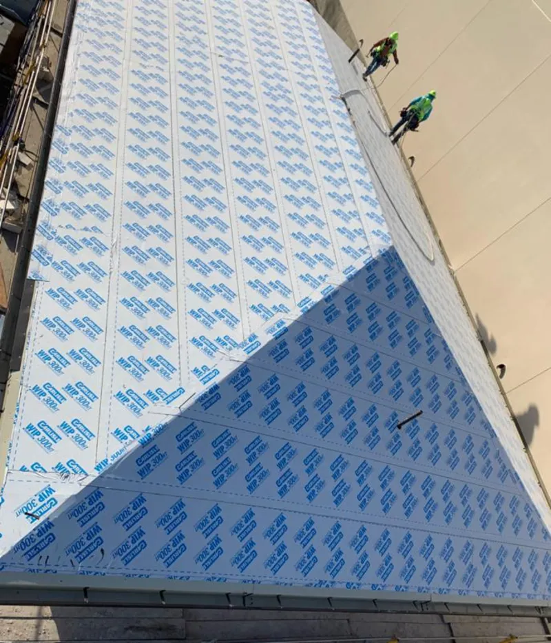 Professional roofers installing underlayment on a metal roof in Carolina Shores